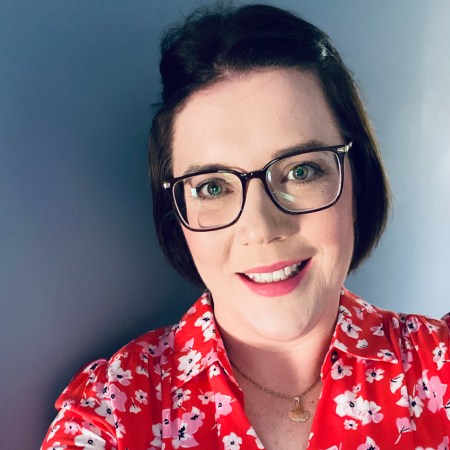 Susan Hunter in red floral dress with glasses