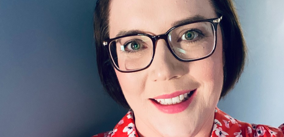 Susan Hunter in red floral dress with glasses